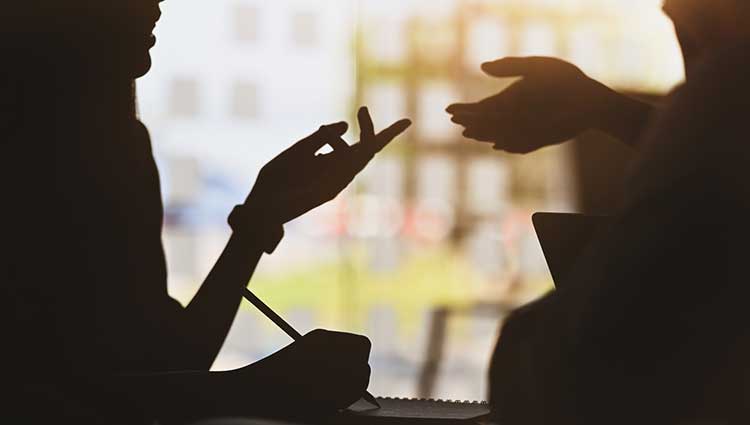 Silhouette of two hands negotiating