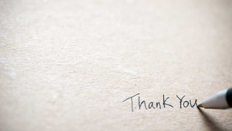 Signature "thank you" on a note card.